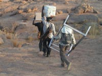 Transporting solar panel over the Bandiagara Escarpment Transporting solar panel over the Bandiagara Escarpment