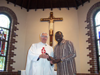 Fr. Jo receives gift from Zakari - SS John Fisher and Thomas More RC Church