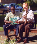 Chairman of the Community Council, Bruce Speed, exchanges gifts with Zakari
