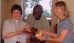 A book about the Dogon being presented to the library by Revd. Mirella Moxon